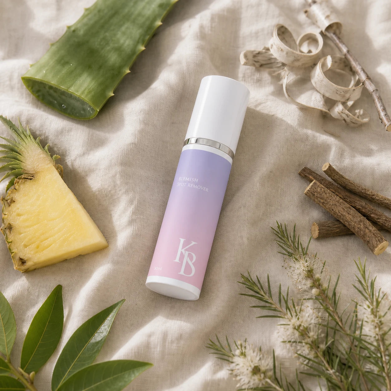Kaloneo Beauty Blemish Spot Remover laid on linen with aloe vera, pineapple, white willow bark, licorice root, lemon myrtle and tea tree blossom, the botanicals used in the formula