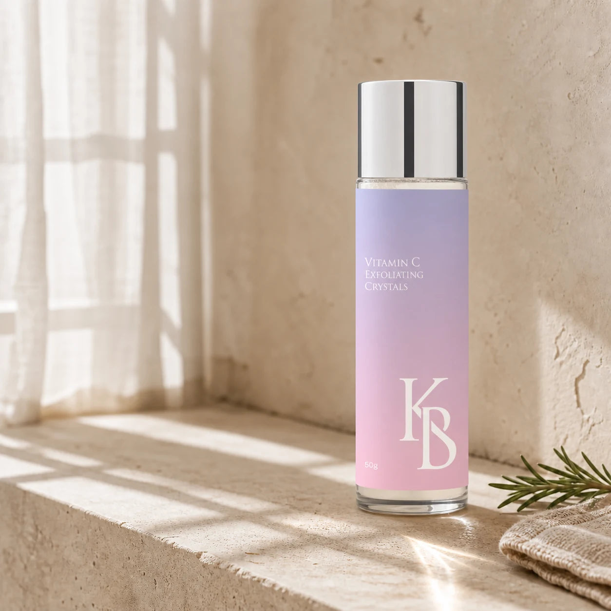 Kaloneo Beauty Vitamin C Exfoliating Crystals 50g in a clear glass bottle on a travertine bathroom ledge in warm morning light