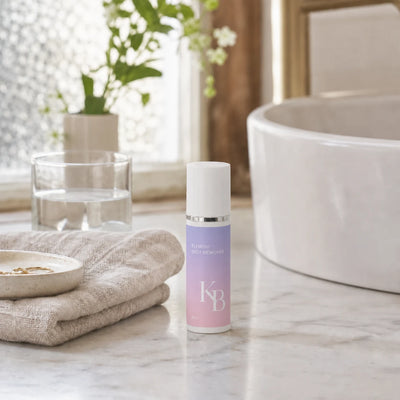Kaloneo Beauty Blemish Spot Remover 30ml on a marble vanity beside a folded linen towel, a ring dish and a ceramic basin in soft morning light