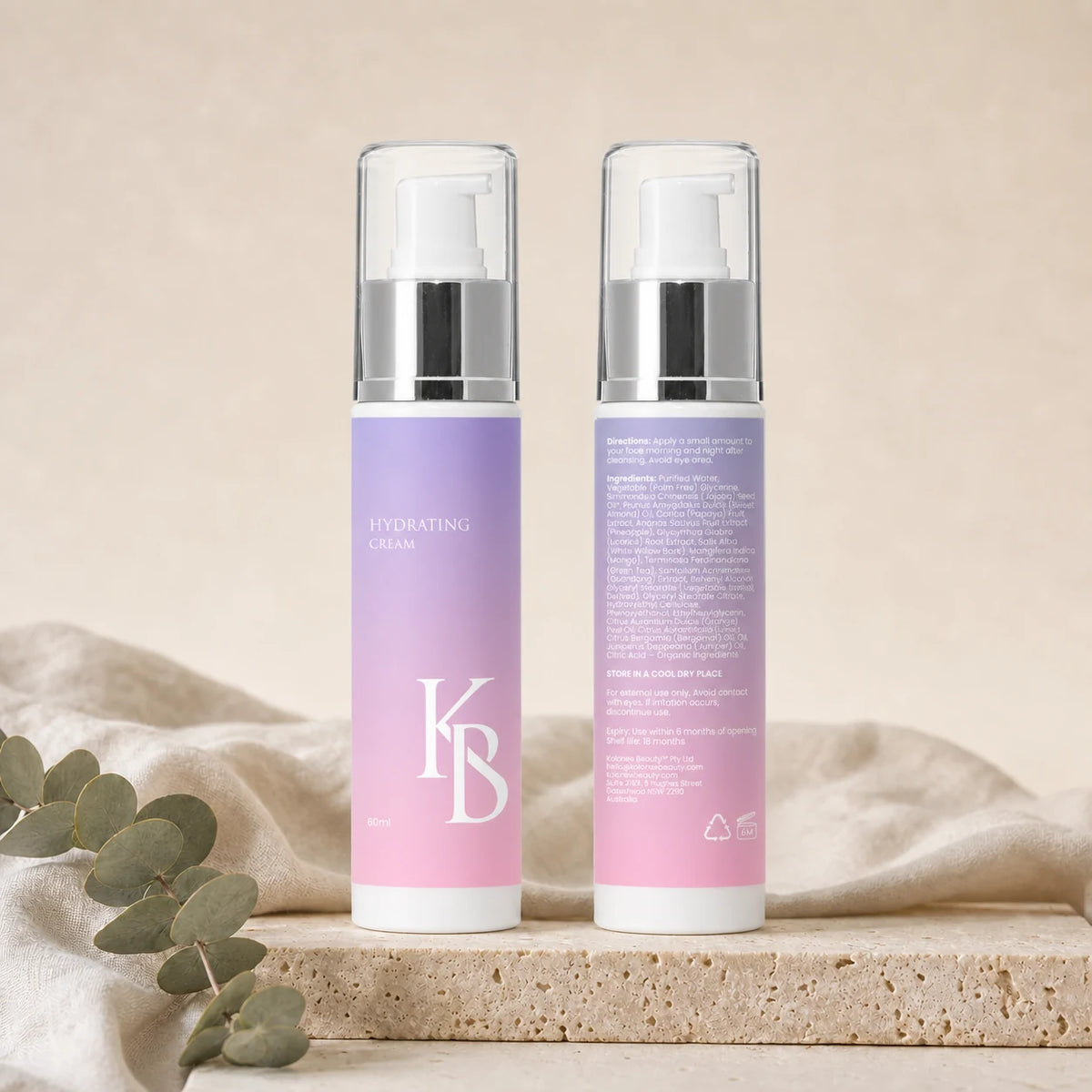 Kaloneo Beauty Hydrating Cream front and back labels side by side on a travertine plinth with eucalyptus, the back showing the full ingredients list, directions for use and Australian address