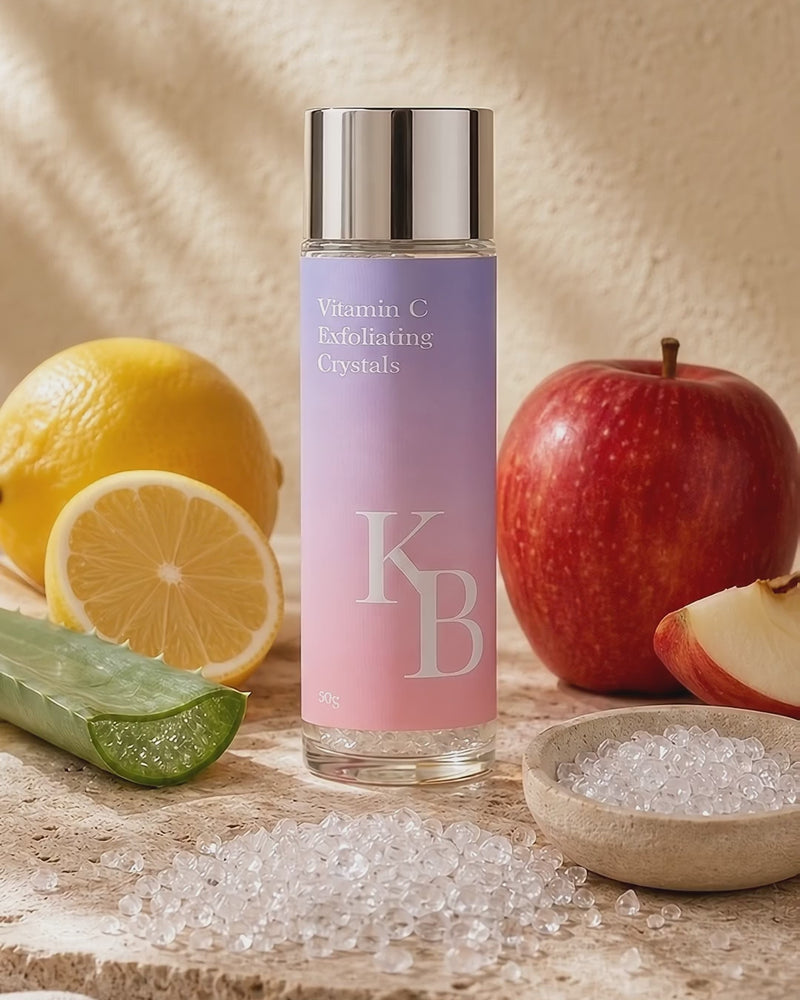 Kaloneo Beauty Vitamin C Exfoliating Crystals on travertine stone with the loose crystals, lemon, red apple and aloe vera in warm morning daylight - portrait product film with music
