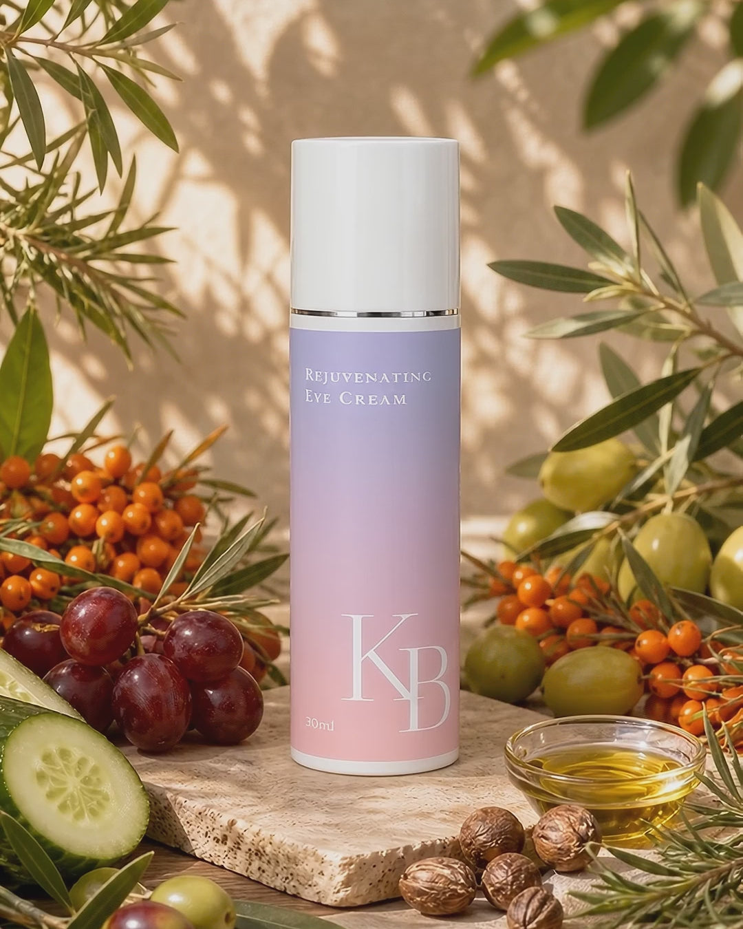 Load video: Kaloneo Beauty Rejuvenating Eye Cream on travertine stone surrounded by sea buckthorn berries, olive and lemon myrtle branches, cucumber and red grapes in warm daylight - portrait product film with music